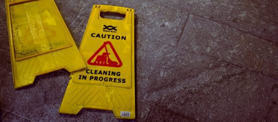 Two wet floor signs on the ground